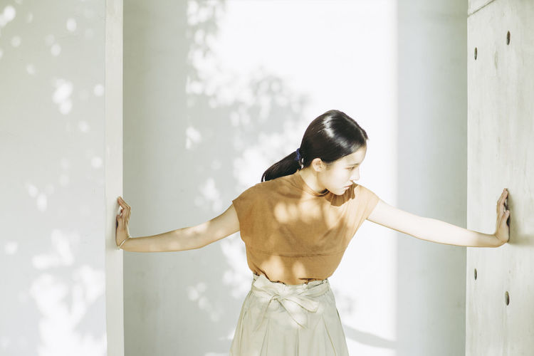 Woman standing against wall