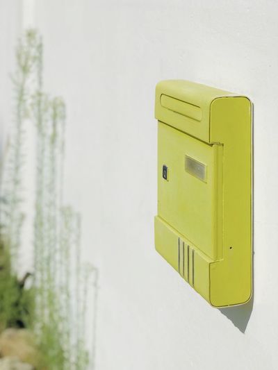 Close-up of mailbox against wall