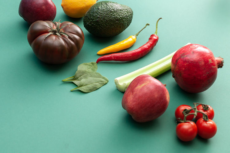 Various fruits and vegetables on green background