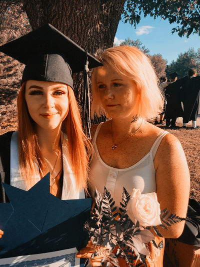 Mother observes daughter on graduation day, proud of her accomplishments but hesitant to se her go.