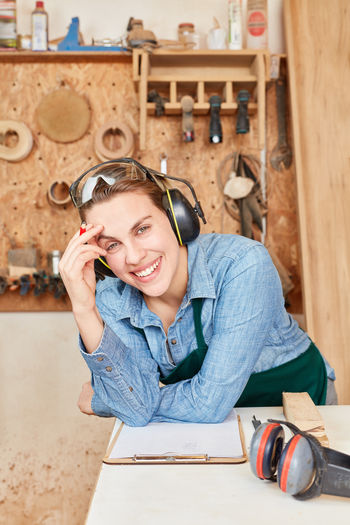 Portrait of smiling female carpenter at workshop