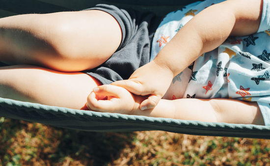 Low section of baby lying on hammock