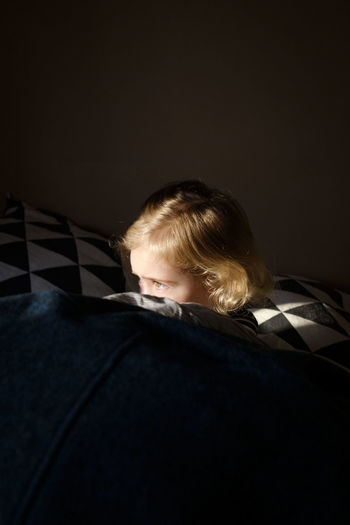 High angle view of girl lying on bed at bedroom