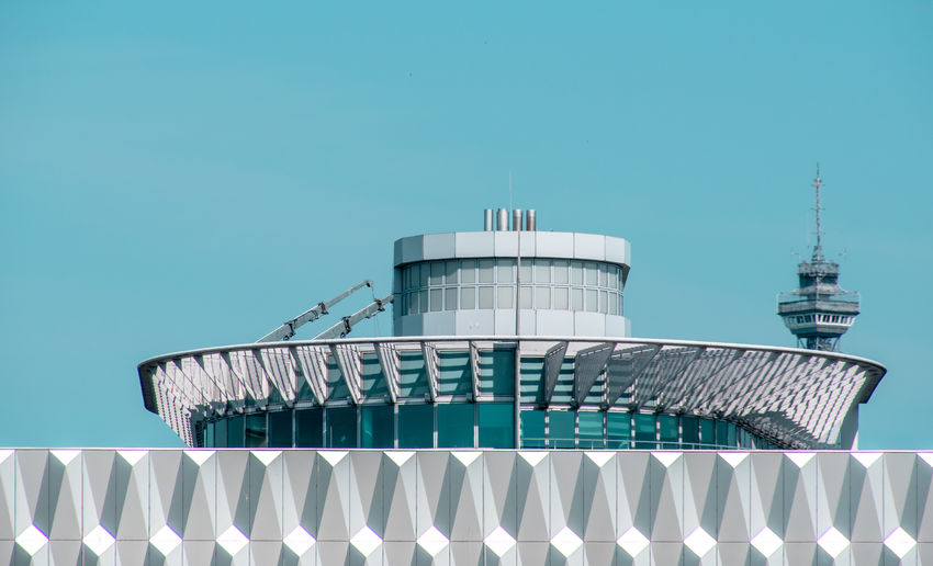 Low angle view of modern building against blue sky