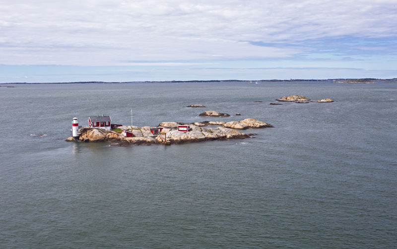 Lighthouse and red house on rocky island in gothenburg archipelago, near goteborg