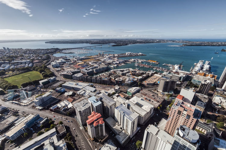 High angle view of buildings by sea against sky