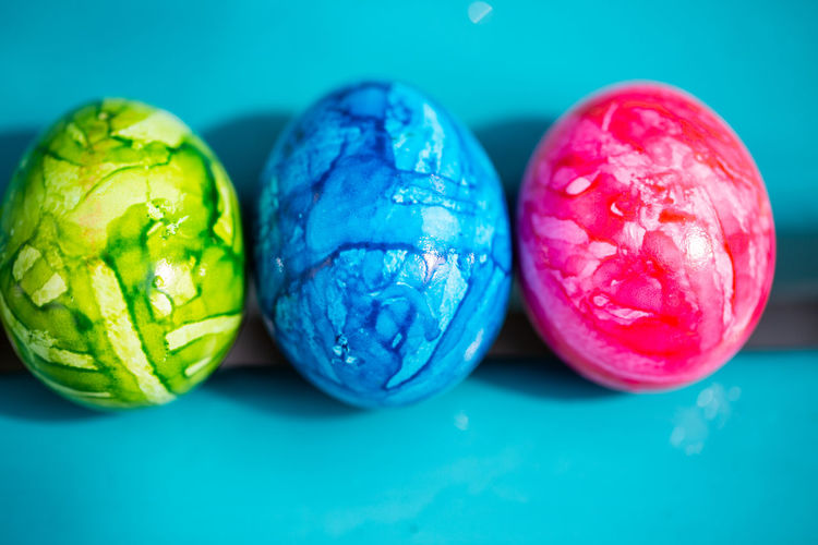 Close-up of colorful easter egg on blue background
