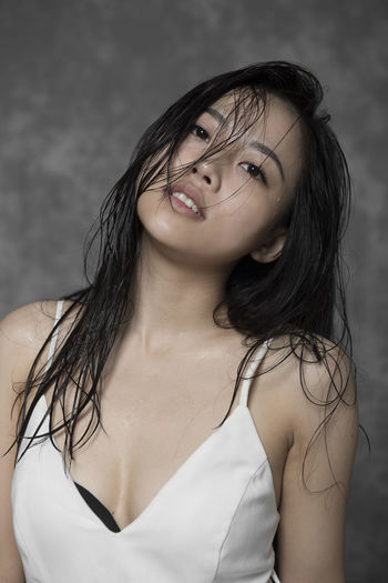 Portrait of beautiful woman against white background