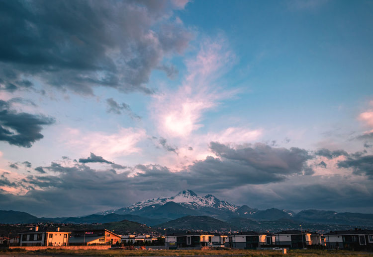 Scenic view of townscape against sky at sunset