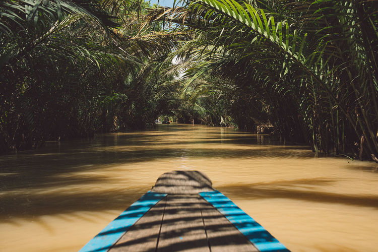Wooden rowboat in river at forest