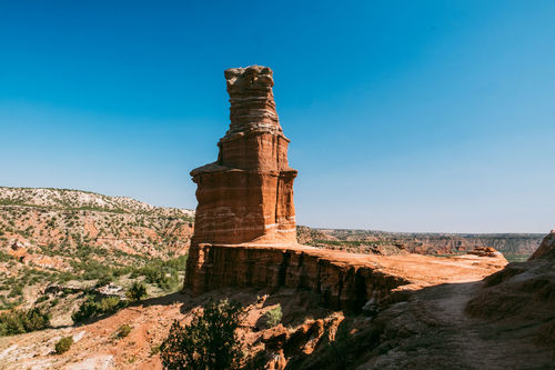 View of rock formation against blue sky