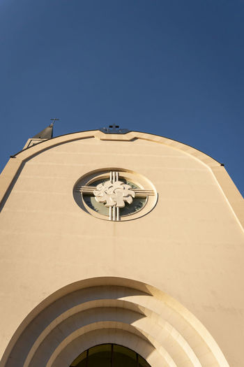 Low angle view of building against clear blue sky