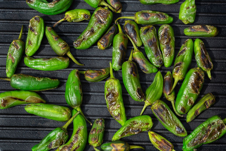 Grilled green hot mexican peppers jalapeno. typical spanish tapas, pimientos de padron