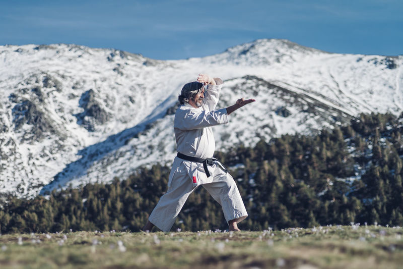 Senior man practicing karate outdoors