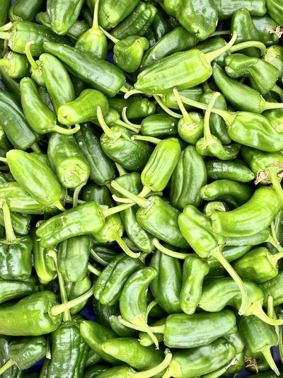 Full frame shot of green chili peppers at market stall