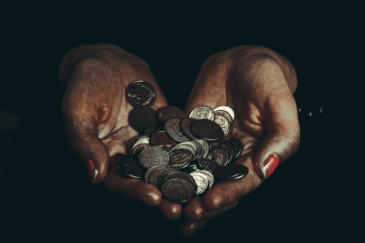 Close-up of human hand against black background
