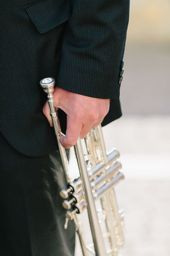 Cropped image of musician holding trumpet