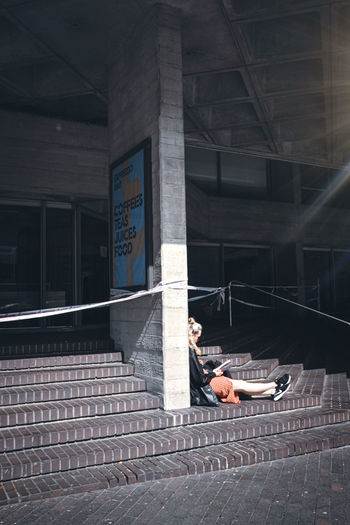 Man lying down on building