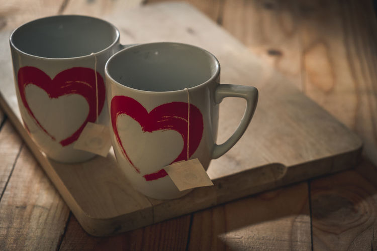 Close-up of heart shape coffee cup on table