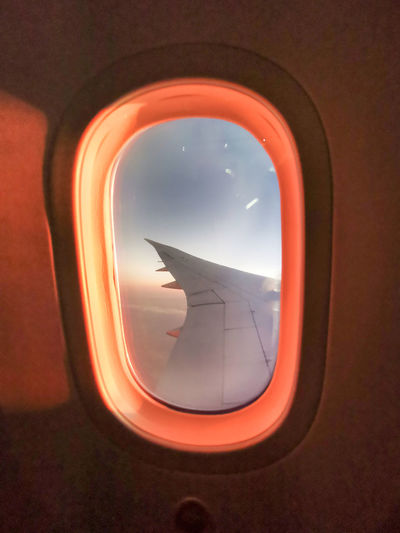 Reflection of sky seen through airplane window