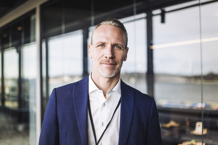 Portrait of male entrepreneur standing at workplace