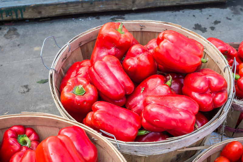 High angle view of red chili peppers in basket at market