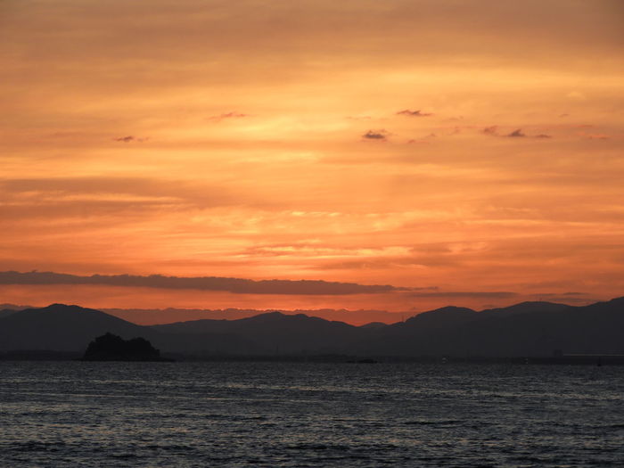 Scenic view of sea against romantic sky at sunset