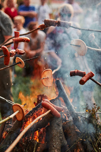 People preparing food on bonfire
