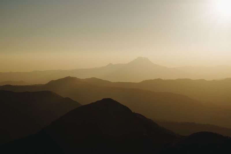 Scenic view of silhouette mountains against sky during sunset