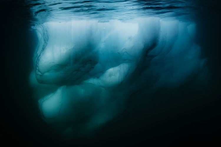 Underwater image of a drifting iceberg at prins christians sund, north atlantic sea, greenland. 