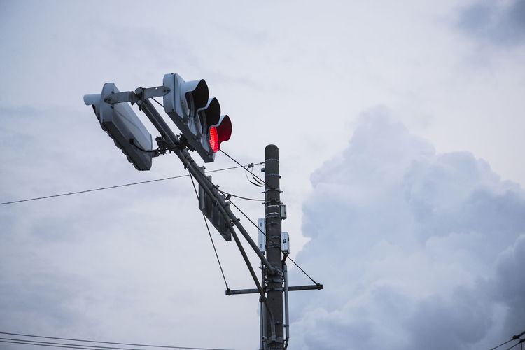 Low angle view of traffic signal against sky