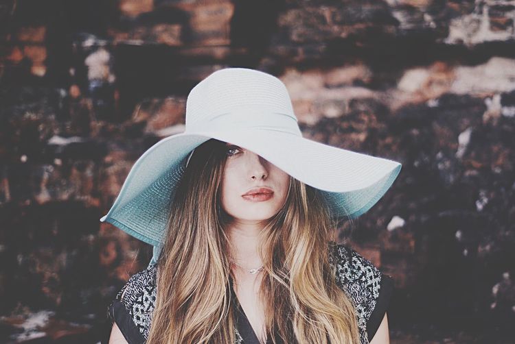 Portrait of beautiful woman wearing sun hat