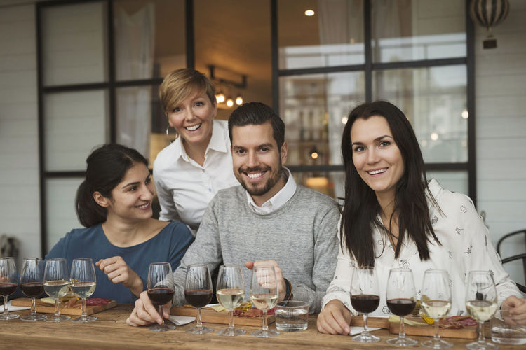 Portrait of smiling business people during winetasting at table