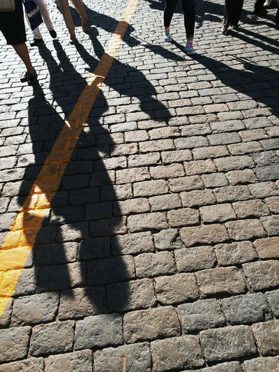 Low section of people walking on footpath