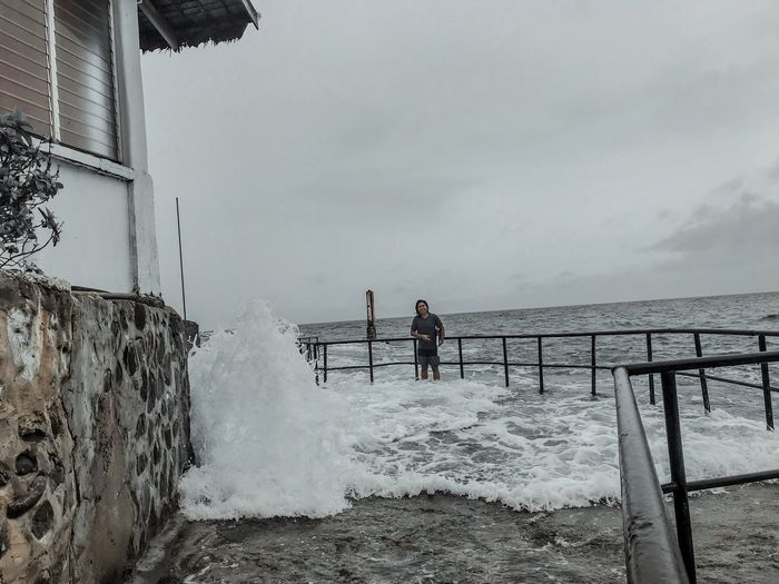 People on sea shore against sky