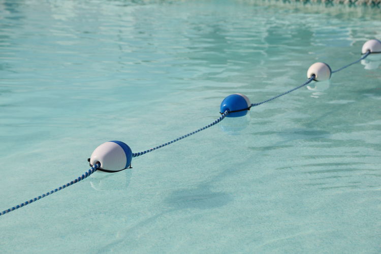 High angle view of rope and buoys on swimming pool