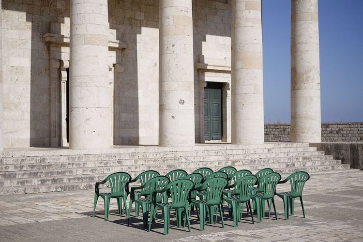 Empty chairs outside historic building
