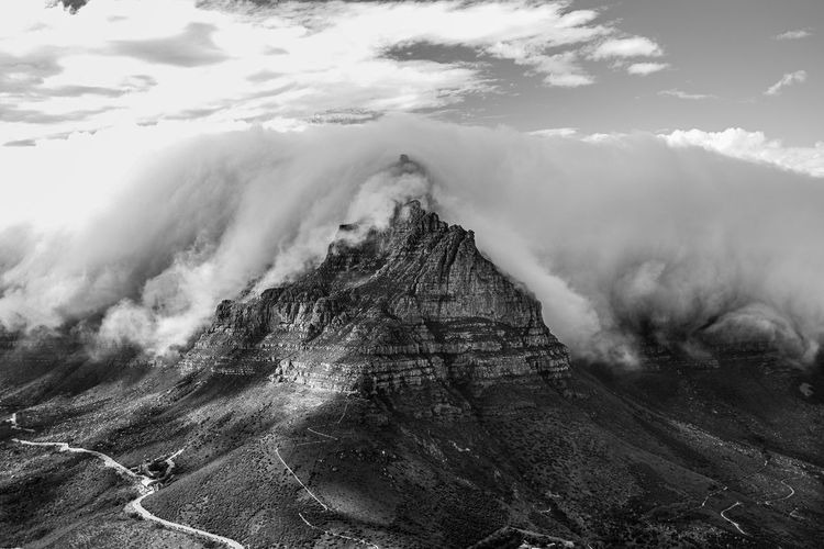 Iconic table mountain with tablecloth clouds as seen from lion's head in cape town, south africa