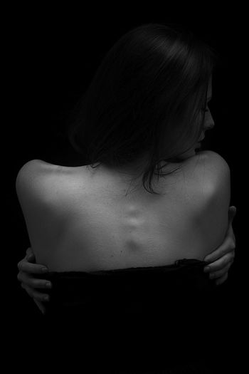 Young woman in black background