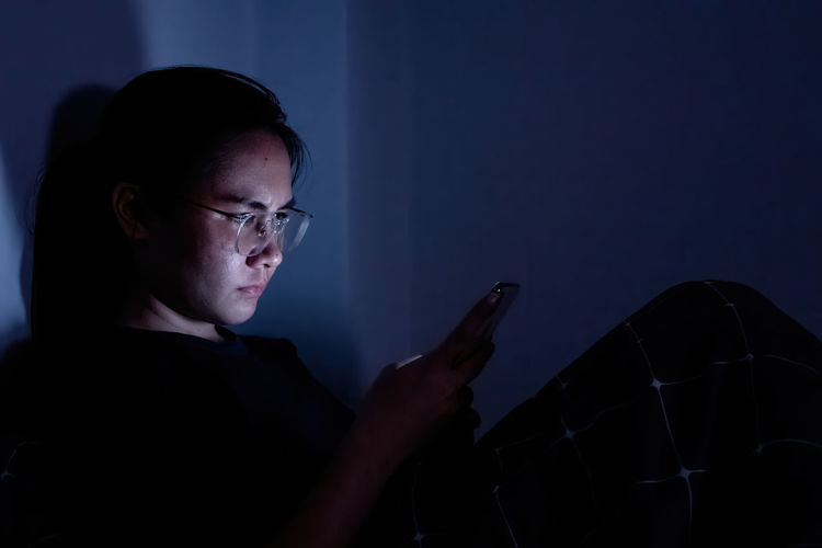 Midsection of man using mobile phone