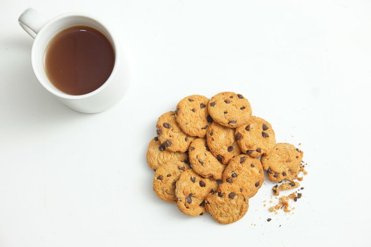 High angle view of cookies and coffee on white background