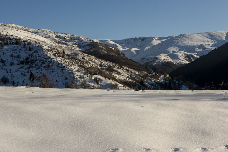 Scenic view of snowcapped mountains against clear sky