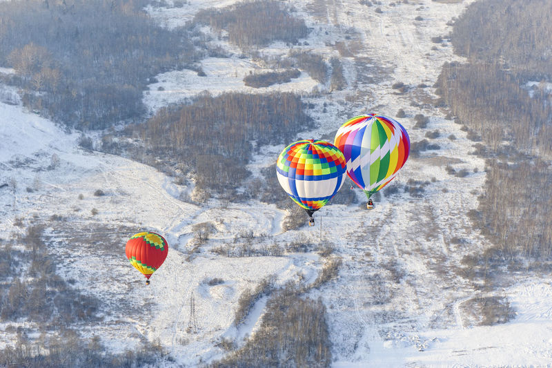 Multi colored balloons flying over sea on sunny day