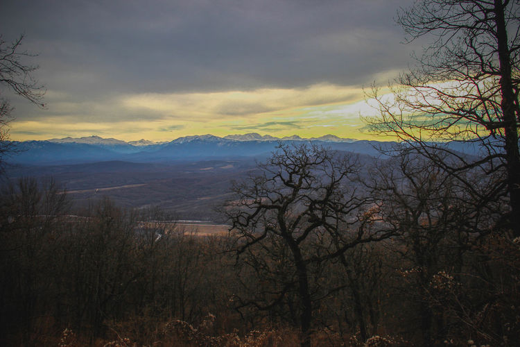 Scenic view of mountains against sky at sunset