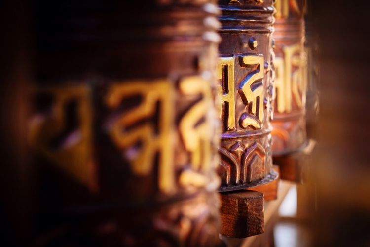 Close-up of prayer wheel in buddha temple
