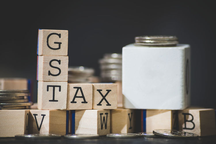 Close-up of gst text on wooden blocks