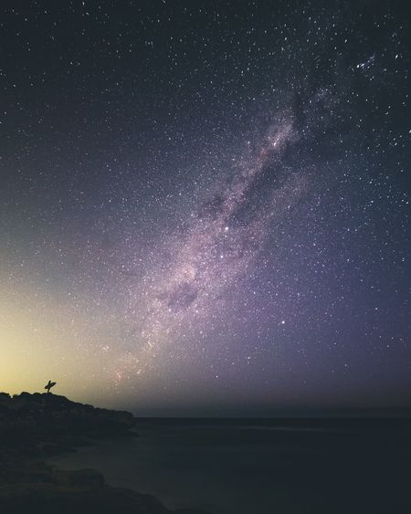 SCENIC VIEW OF SEA AGAINST STAR FIELD