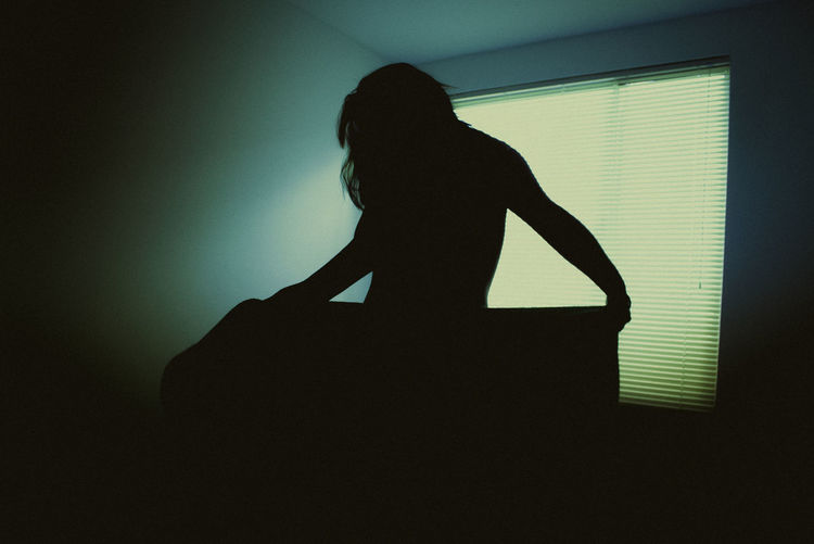 Silhouette woman sitting in a room