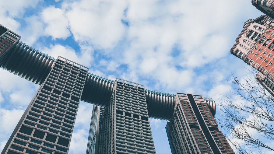 Low angle view of modern buildings against sky