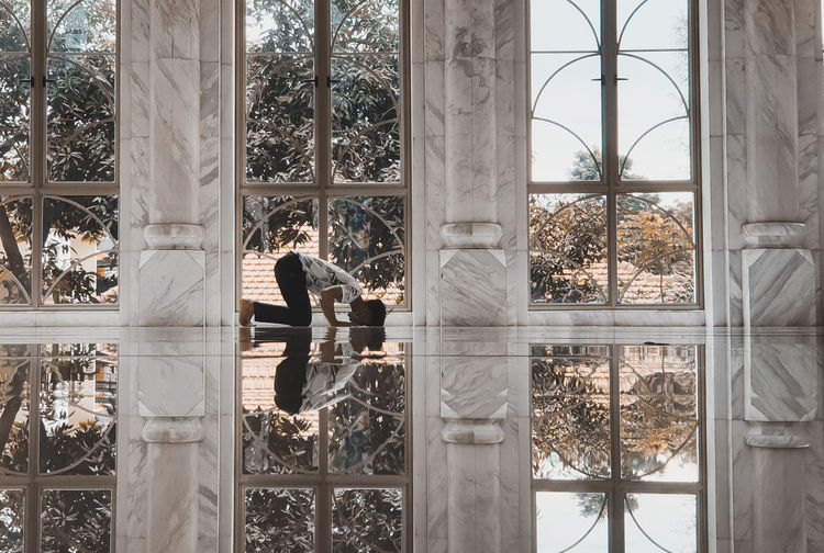 Reflection of man on glass window
